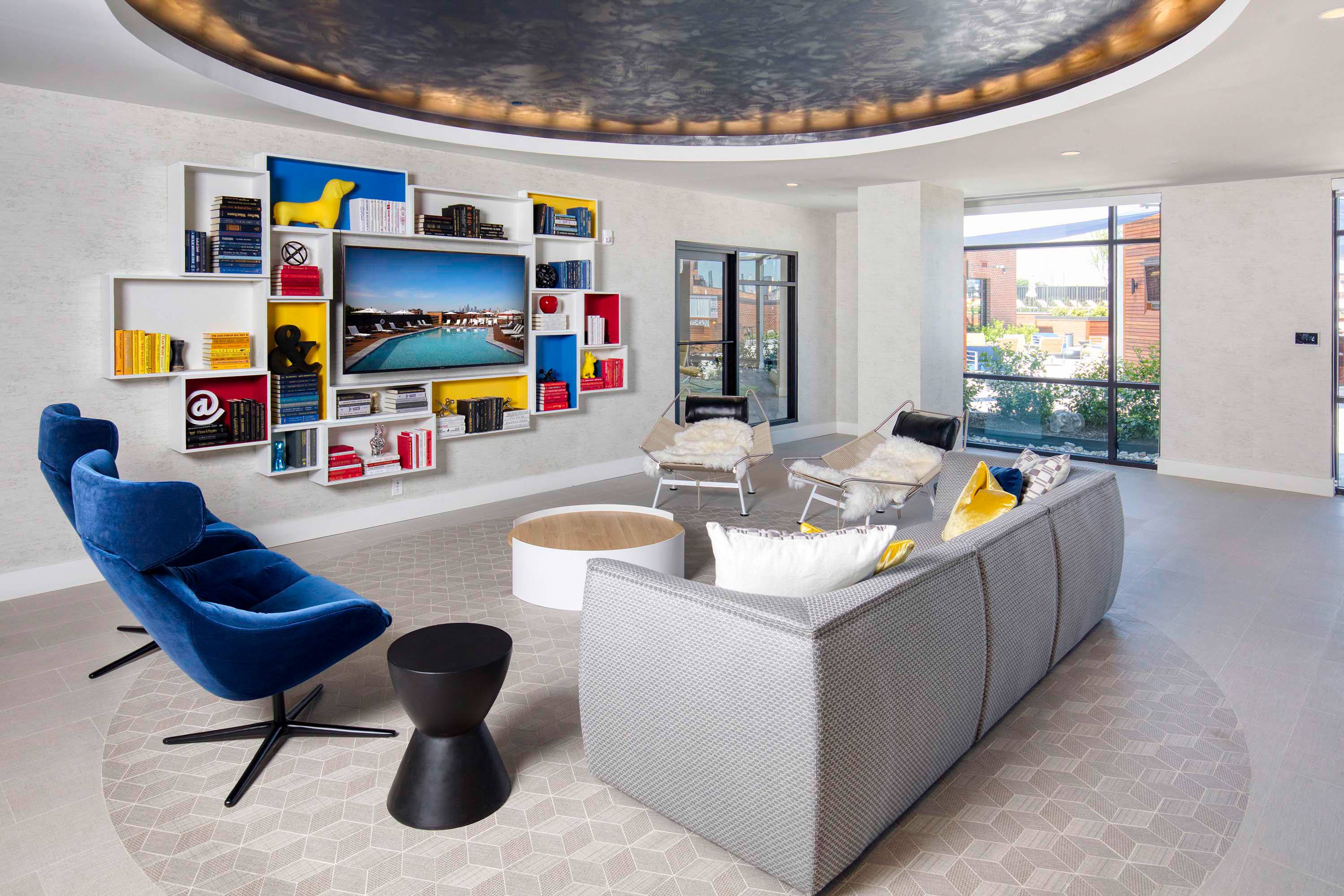 a living room with a couch and chairs and a television